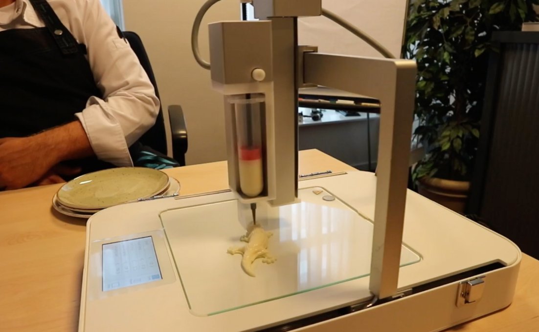 de 3d voedselprinter is eten aan het printen in de vorm van een salamander